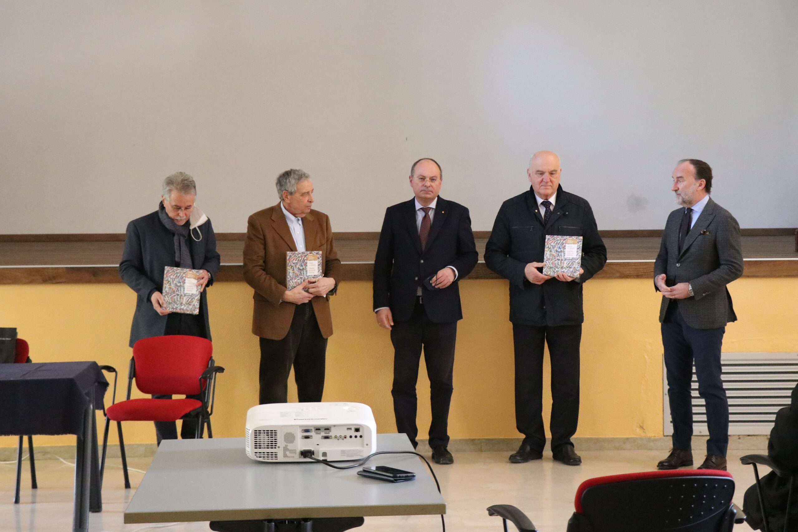 the final greetings with the delivery of the book dedicated to the hundred years of the Scuola Mosaicisti del Friuli